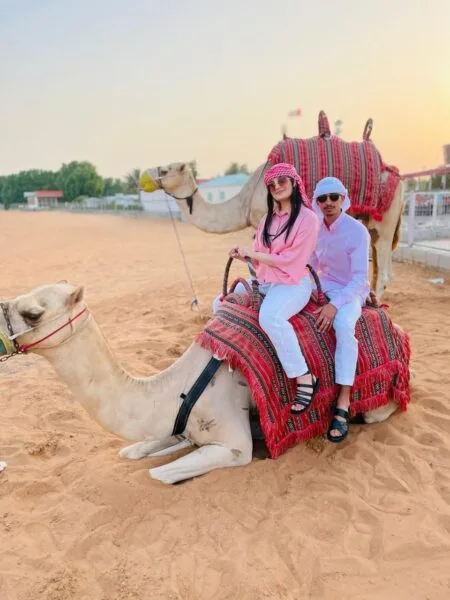 a family sitting on camel
