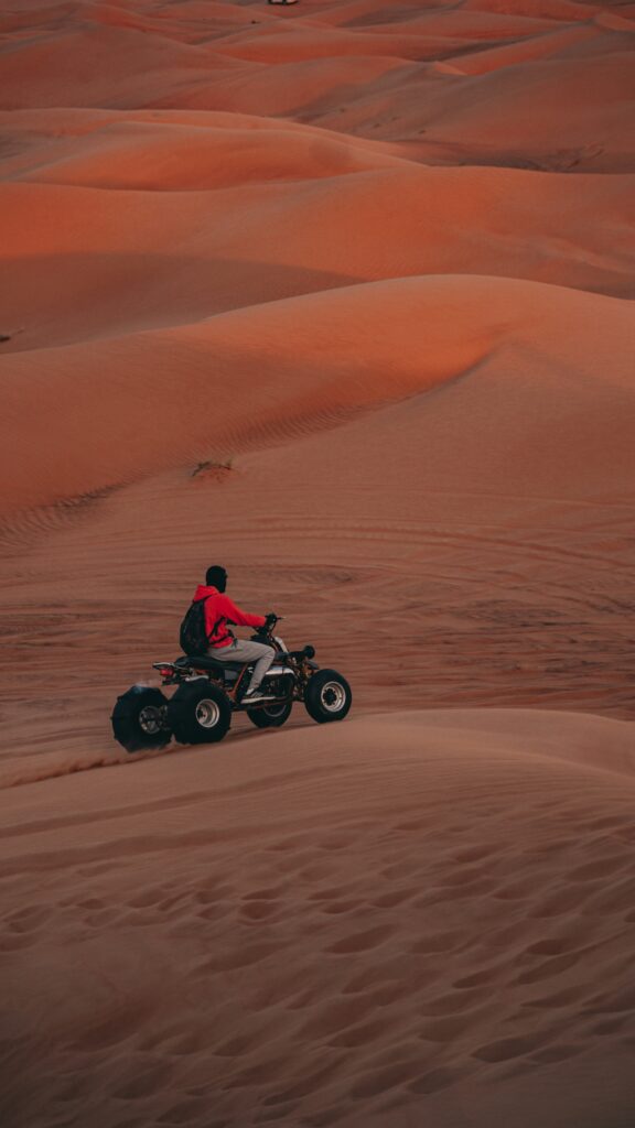 Experience the Ultimate Luxury Desert Safari in Dubai A Man Riding on Motor Bike Experience the Ultimate Luxury Desert Safari in Dubai
