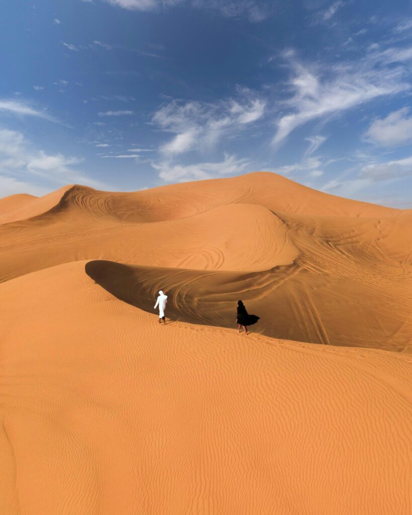 A Couple Walking in Desert VIP Desert Safari Dubai