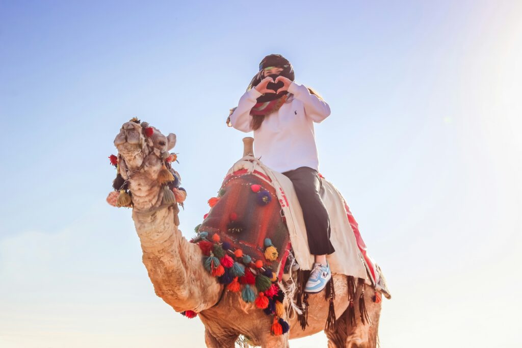 A Girl Riding on Camel Safari Dubai Timings