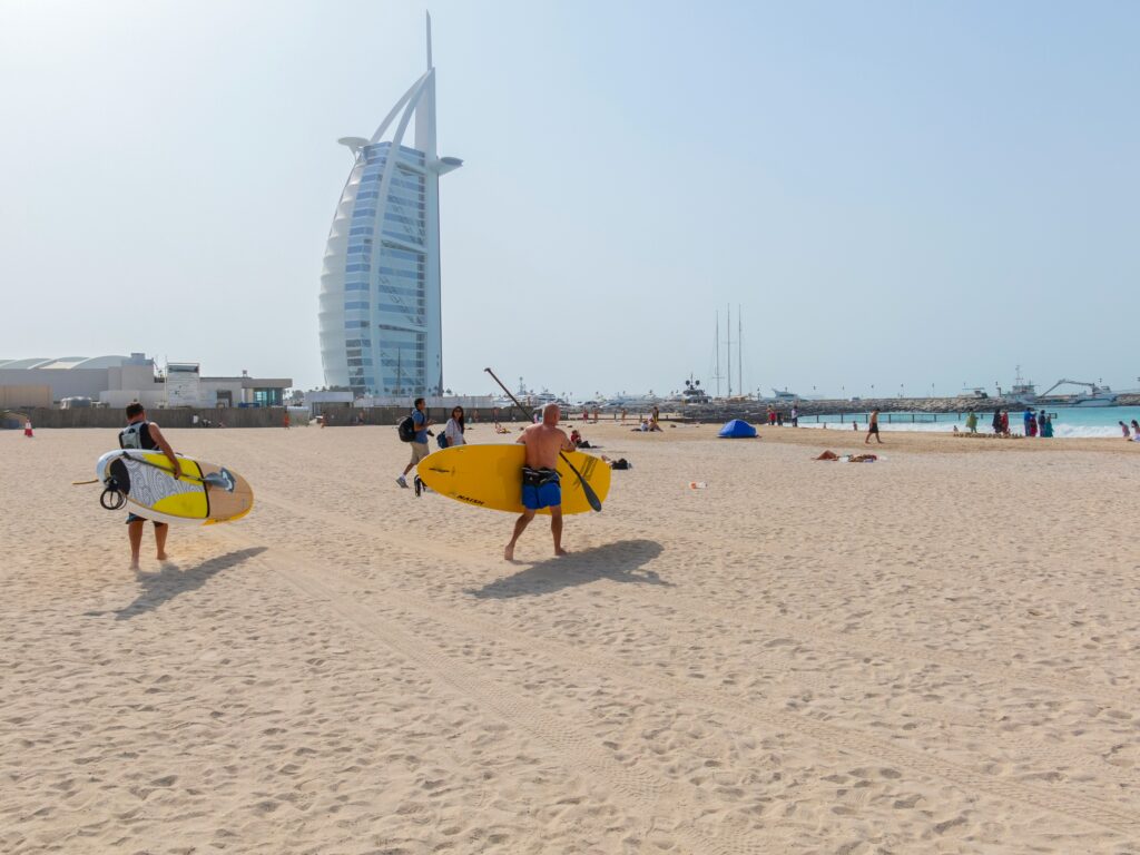 Two Mans Going for Sandboardin on Beach Sandboarding Dubai g