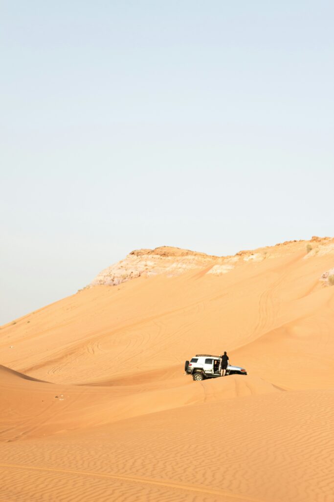 A Man With White Jeep in Unique Desert Safari Camp in Dubai