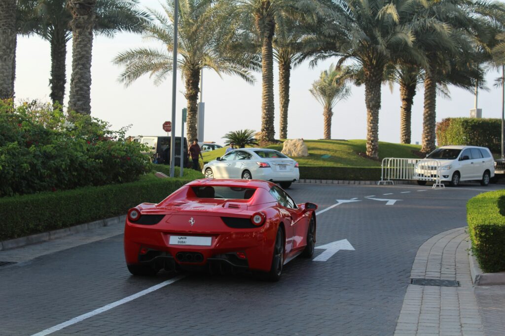 A Red Sports Car Running on Road Things to Do in Dubai