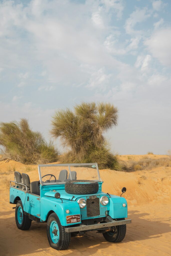 A Blue Car Standing in Desert Safari Sharjah 