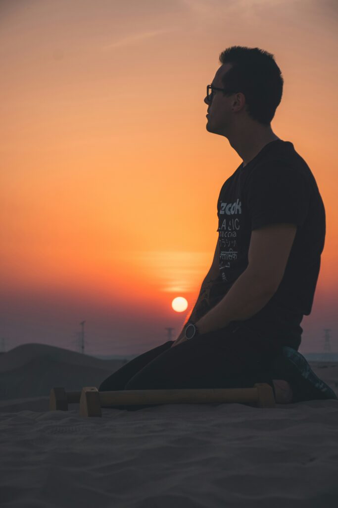 A in Black T Shirt Sitting on Sand Dune Abu Dhabi