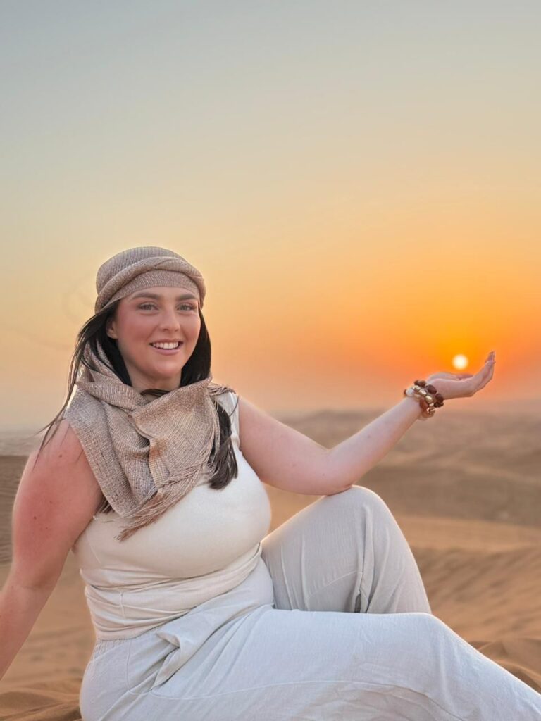 A women sitting on sand
