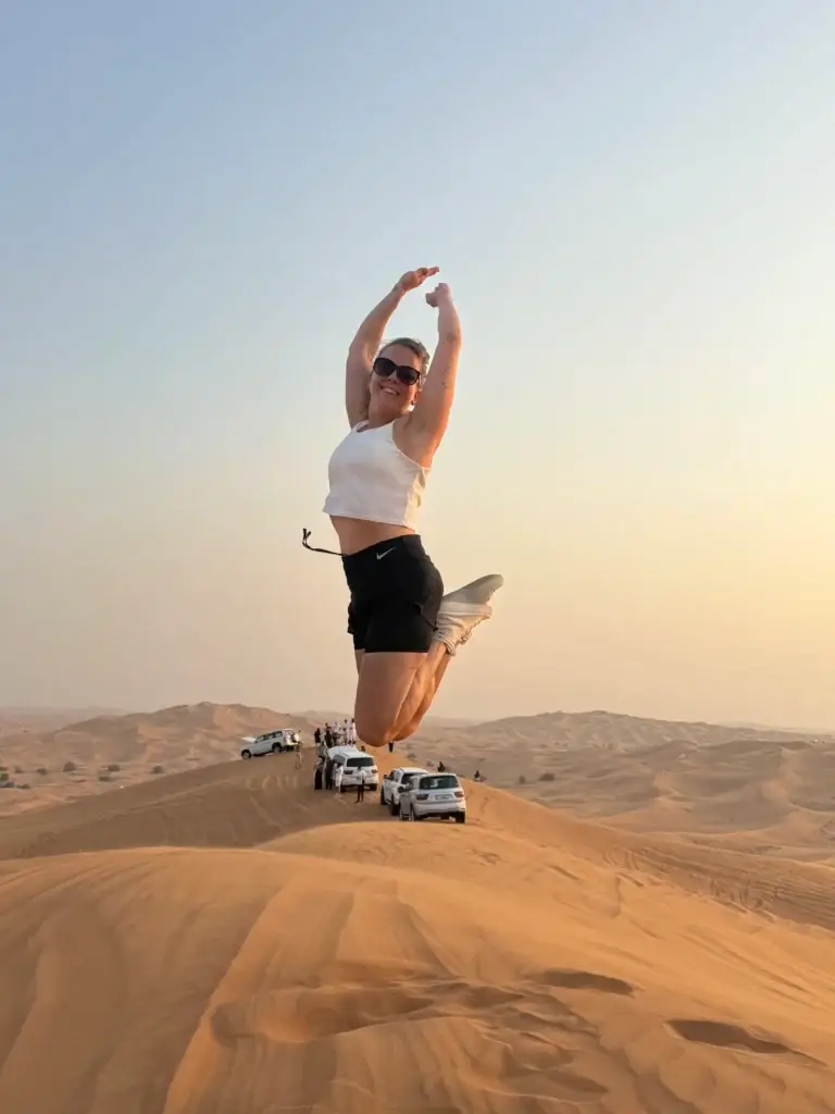 a women jumping in desert